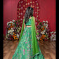 Grace Your Festivities With This Vibrant Green Lehenga Set, Featuring Floral Embroidery And A Flowy Printed Skirt