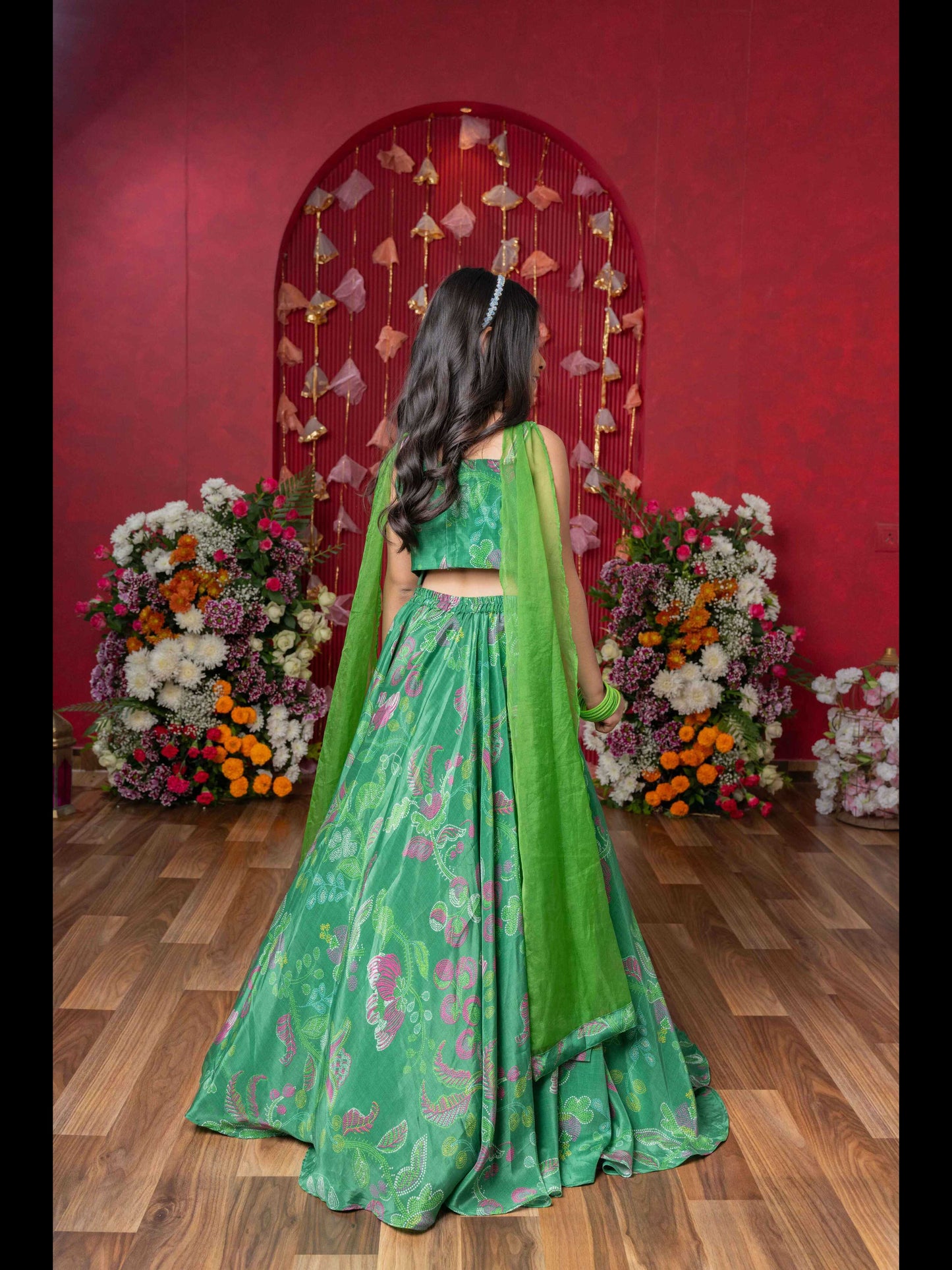 Grace Your Festivities With This Vibrant Green Lehenga Set, Featuring Floral Embroidery And A Flowy Printed Skirt